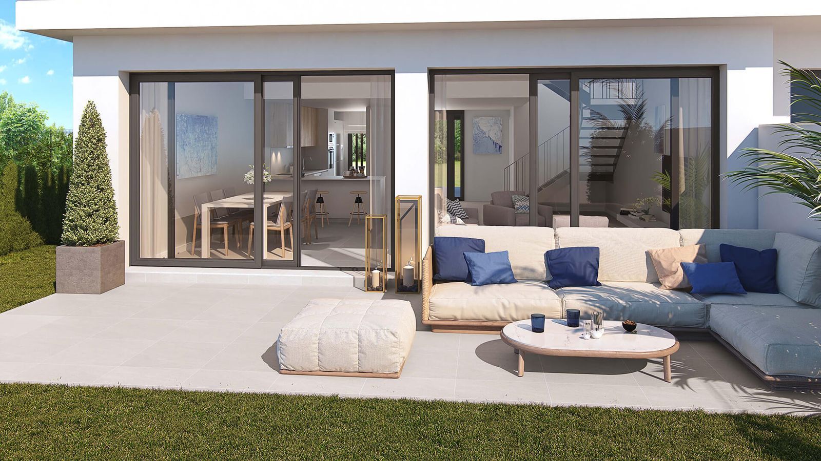 Modern living room with large glass doors, outdoor patio, and greenery view.